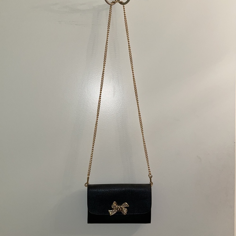 Coach black crossgain leather with crystal embellished gold bow turnlock bag